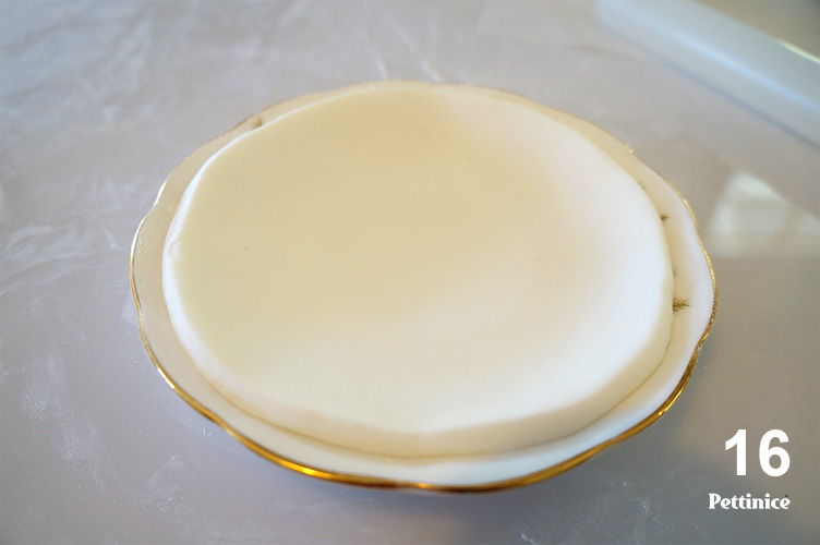 16. Dust the real saucer heavily with either cornflour or icing sugar and allow your piece of fondant to dry on top of the saucer to create the saucer shape, this step can also be done a day before for additional drying time but the addition of Tylose Powder helps the drying time)