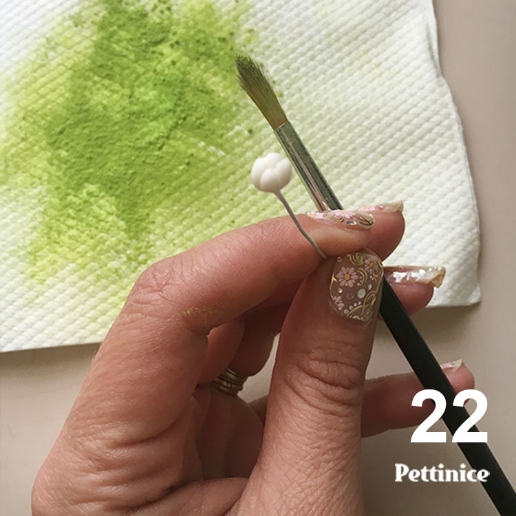 Get some spring green or lime green petal dust on a paper towel.