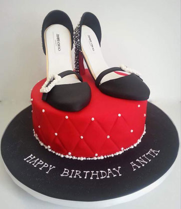 Pair of black heels on red cake by Angela Miller‎