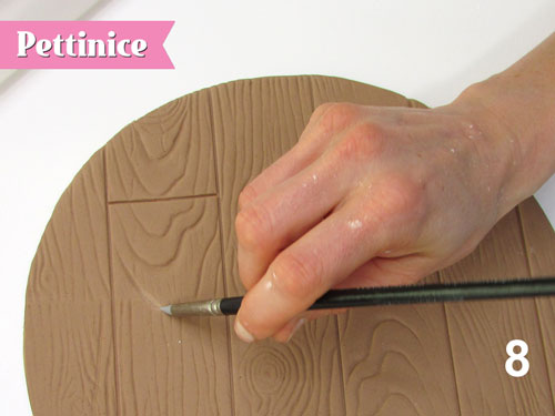Step 8: Use clay smoothing tools to go over any of the wood grain.