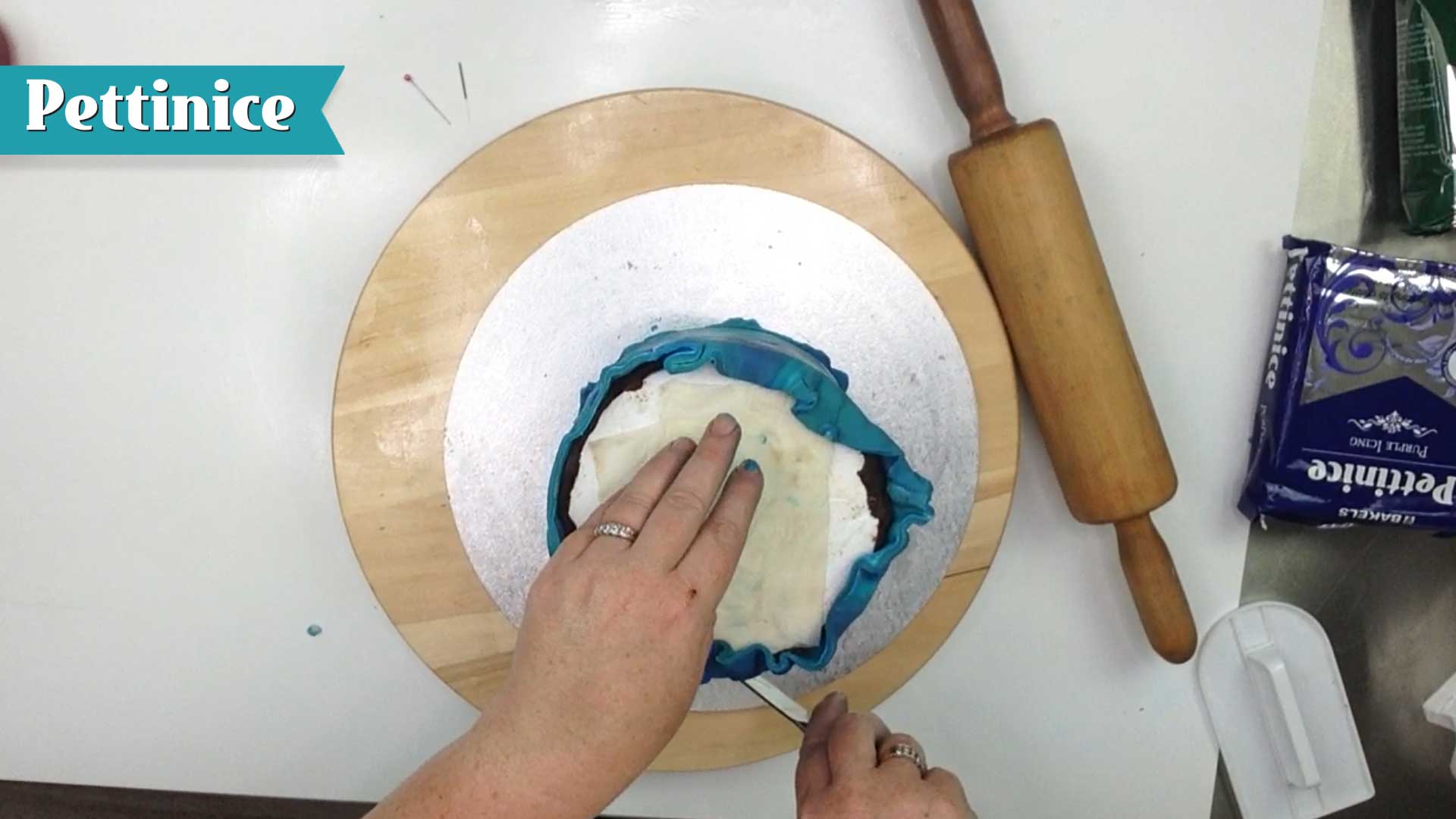 Keeping knife straight, trim off excess fondant.