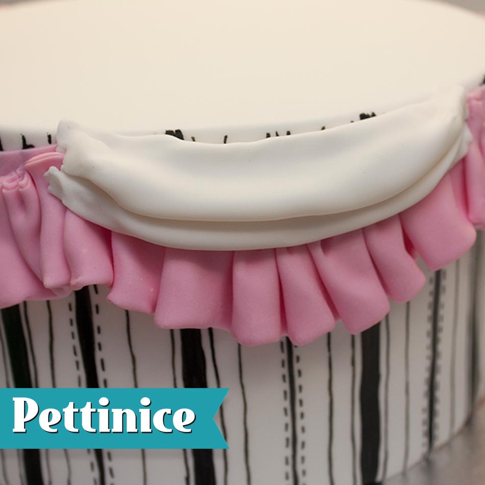 Attach the white folded swag on top of the pink pleats.  Cover the top of the pink pleats as shown.
