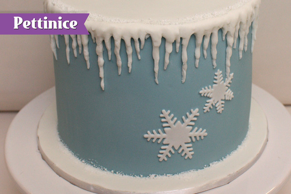 Attach snowflakes to cake as desired.
