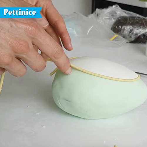 Extrude a thin roll of yellow fondant with a bit of brown to give you a good base for painting gold.