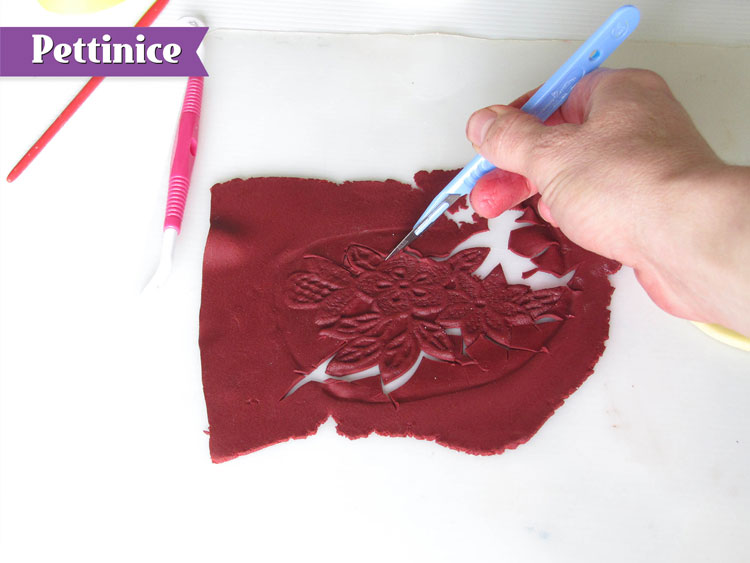 Using your scapel or sharp tool, cut around the lace.