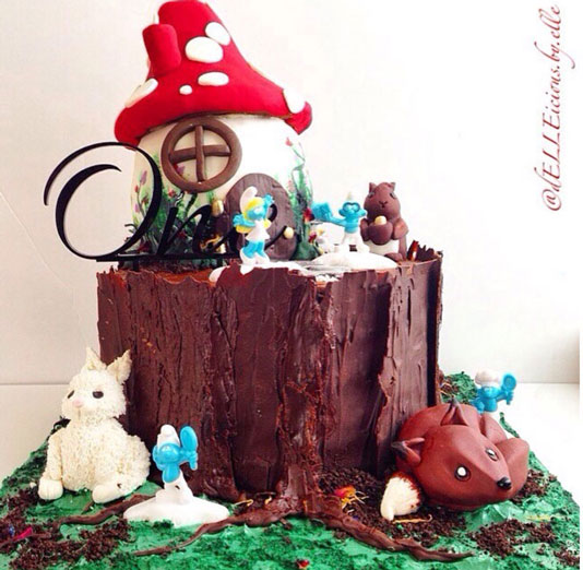 Smurfs and woodland creates cake by Ella West