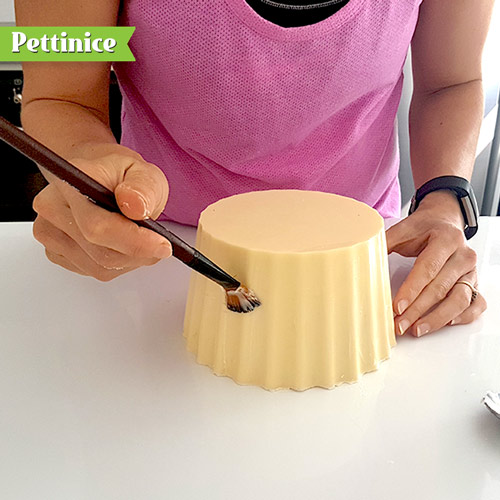 Grab some vegetable fat and paint a layer over the chocolate, this will give the fondant something to stick to.