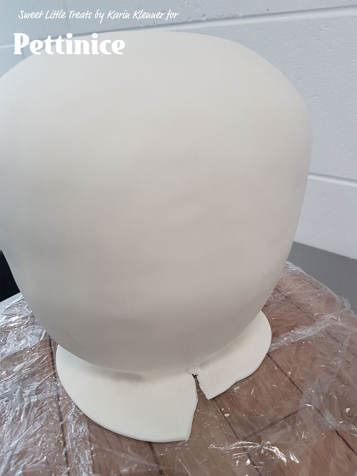 Use you fondant smoother or preferably acetate to push the fondant tidily in around the bottom of the cake,