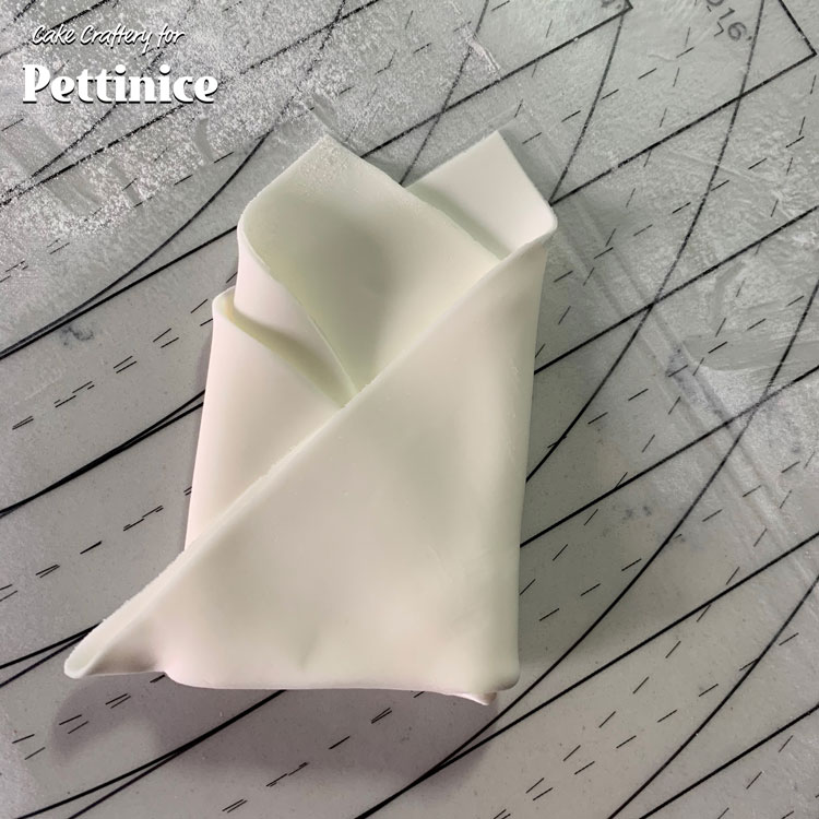 Fold the right side over the left. Dab a little water or edible glue inside the folds to hold them together.