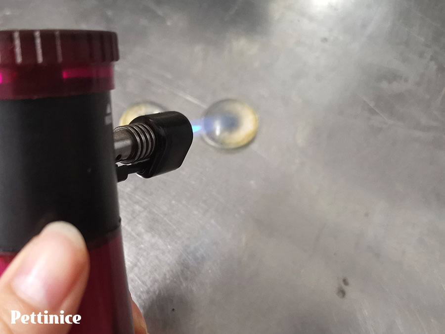 Use a creme brulee torch to quickly heat them, removing all the air bubbles on the surface. Don't do this too long as they will melt again.