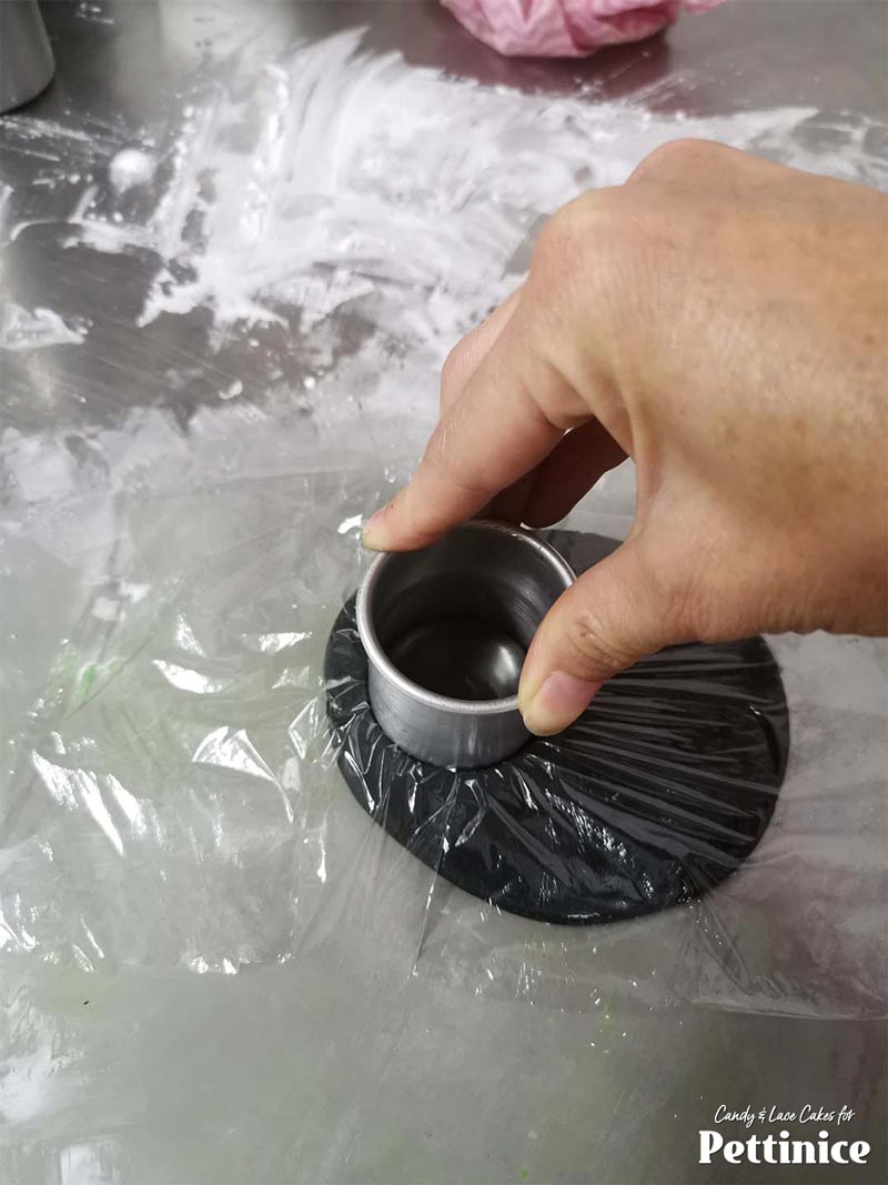 Use a round cutter to cut 2 rounds over the plastic.