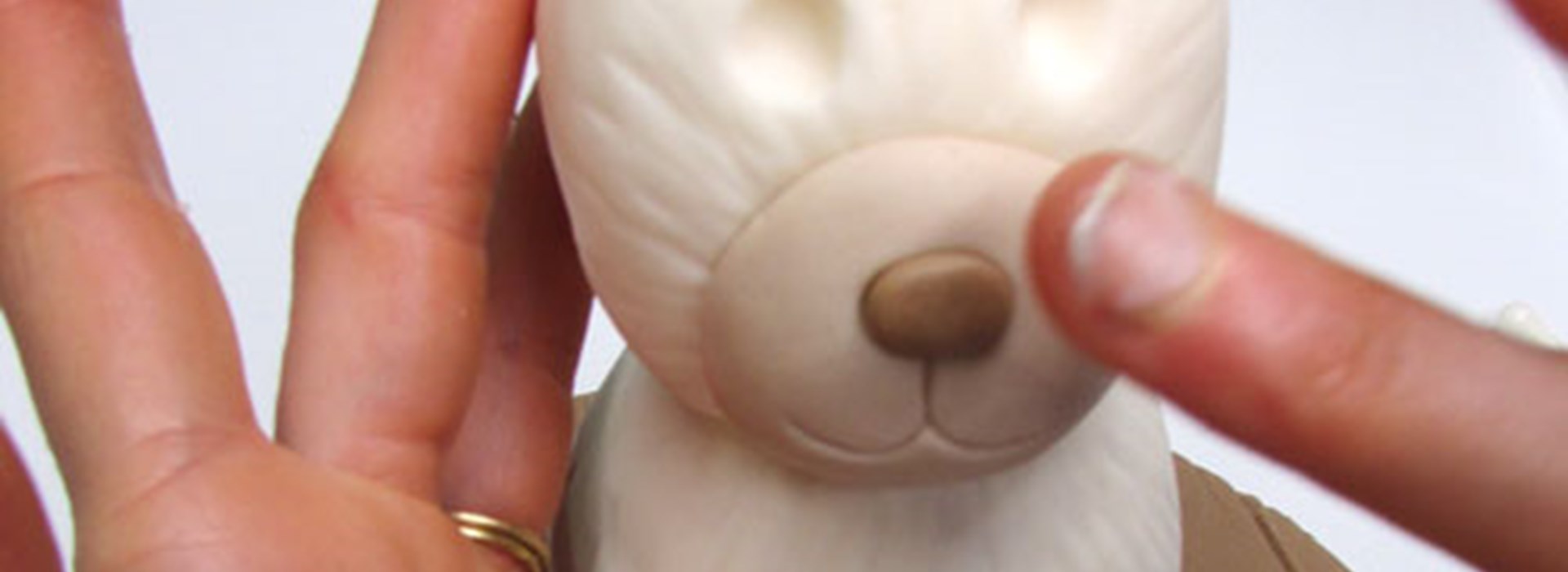 Step 33: Roll a little ball into a nose and press in place.