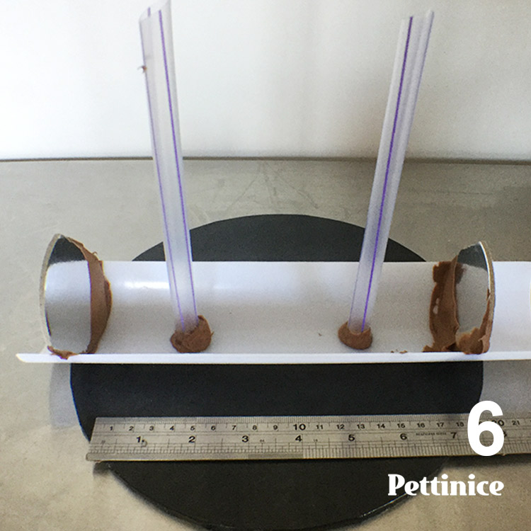 After three attempts, it's easier to skip this step and add the straws AFTER you pour the chocolate.  I kept the photo in as a reminder to use your ruler to check length before pouring.