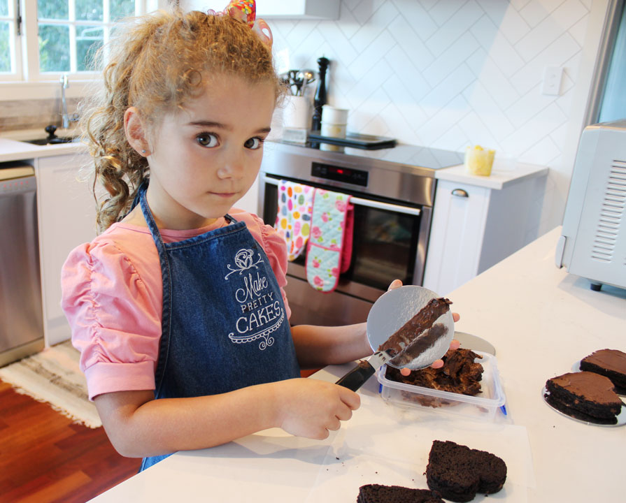 Put a dash of frosting on your cake card to stick the brownie onto it.