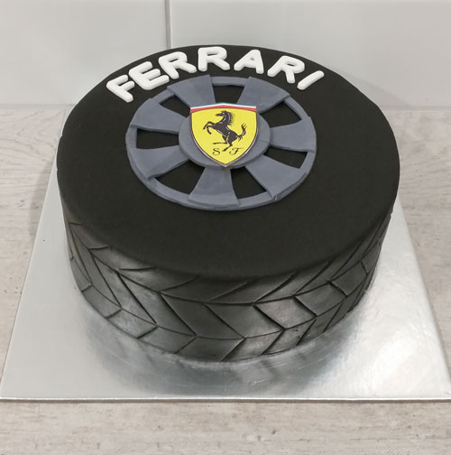 Modern designer chocolate cake in the shape of a car tire as a gift to a