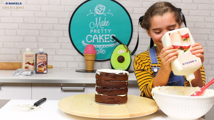 Finish stacking the cake.  One little tip is I whip my truffle mix with a hand blender.  It makes the consistency nice to spread!