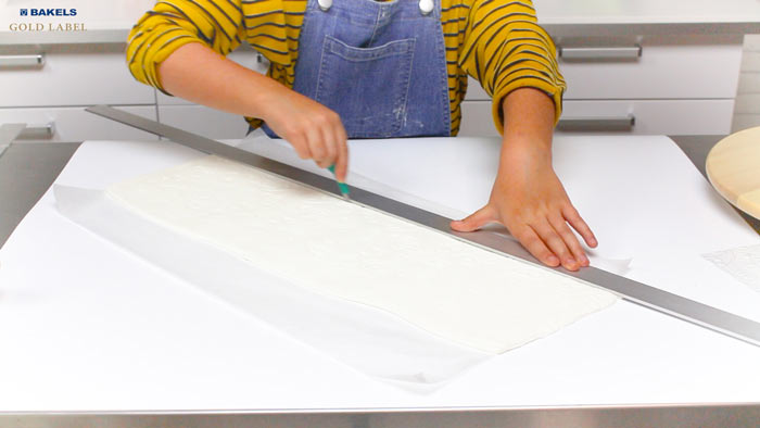 Use your earlier measurements to trim your fondant, but make it 5" longer.