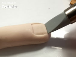 Using your flat tipped tool make indents for the nail.