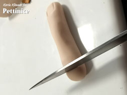 Cut the end of your finger and rough it up to make it look severed.