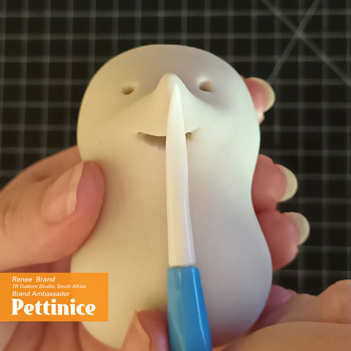 Using the thin side of your Dresden tool, draw a line lightly from the tip of the nose to the inside of the mouth.